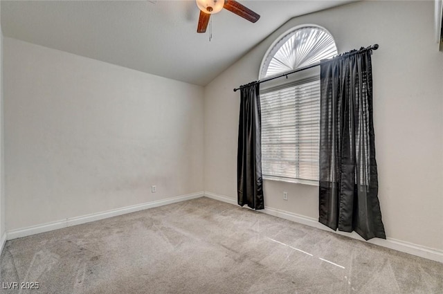 carpeted spare room with a wealth of natural light, ceiling fan, baseboards, and lofted ceiling