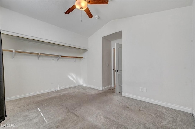 unfurnished bedroom featuring carpet floors, ceiling fan, baseboards, and vaulted ceiling