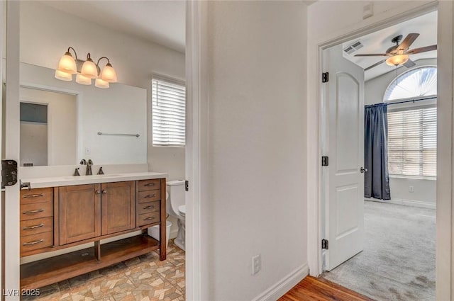 bathroom featuring vanity, visible vents, baseboards, ceiling fan, and toilet