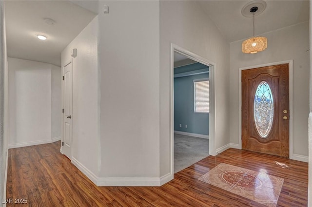 entryway featuring baseboards and wood finished floors