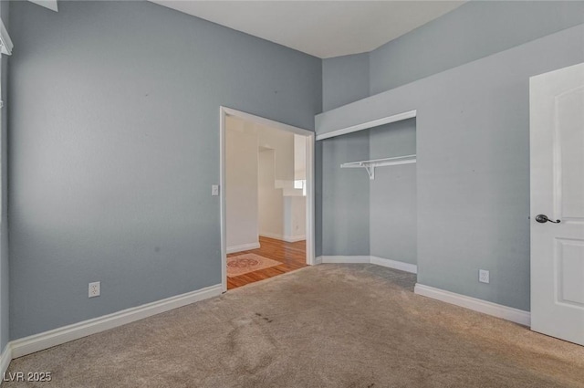 unfurnished bedroom with a closet, baseboards, and carpet floors