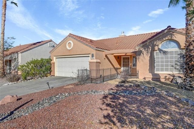 view of front facade with fence, a tiled roof, concrete driveway, stucco siding, and an attached garage