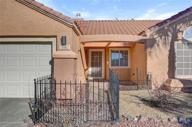 entrance to property featuring a tiled roof, fence, and stucco siding