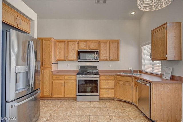 kitchen featuring visible vents, light countertops, appliances with stainless steel finishes, light tile patterned flooring, and a sink