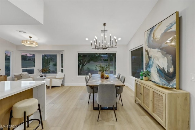 dining room featuring baseboards, visible vents, vaulted ceiling, a notable chandelier, and light wood-type flooring