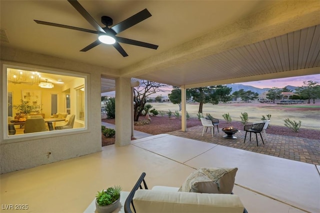 view of patio featuring an outdoor living space with a fire pit, a ceiling fan, and visible vents