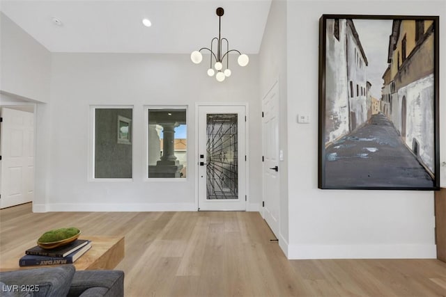 foyer featuring recessed lighting, a chandelier, baseboards, and wood finished floors