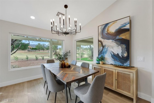 dining area with plenty of natural light, light wood-style flooring, baseboards, and lofted ceiling