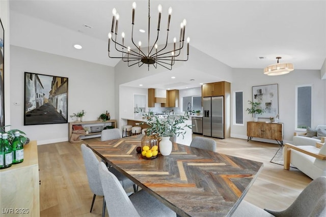 dining space featuring lofted ceiling, recessed lighting, light wood-type flooring, and baseboards