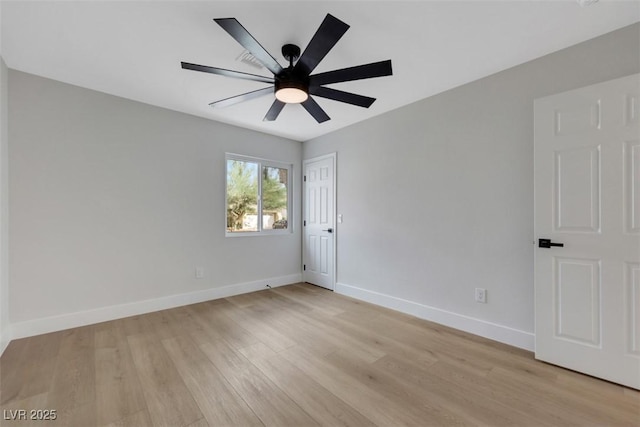 spare room with a ceiling fan, baseboards, and light wood finished floors