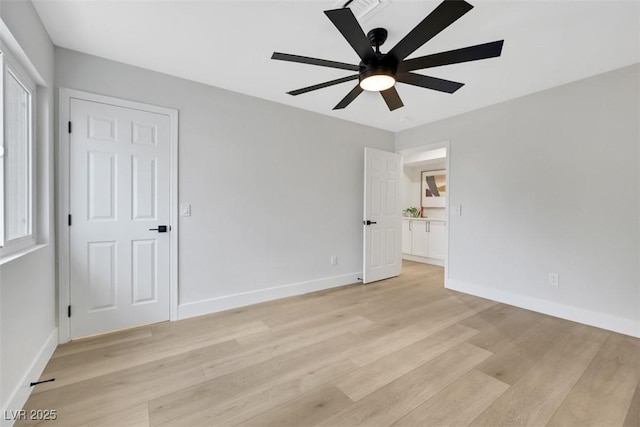 unfurnished bedroom featuring light wood-style flooring, a ceiling fan, and baseboards