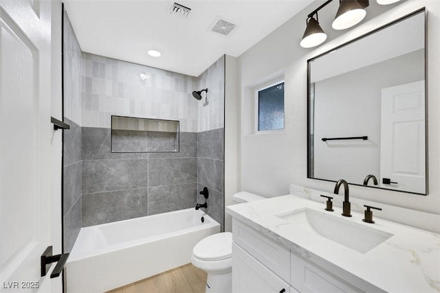 full bathroom featuring visible vents, toilet, shower / washtub combination, and vanity