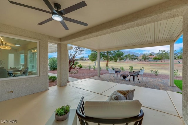 view of patio featuring a fire pit and ceiling fan