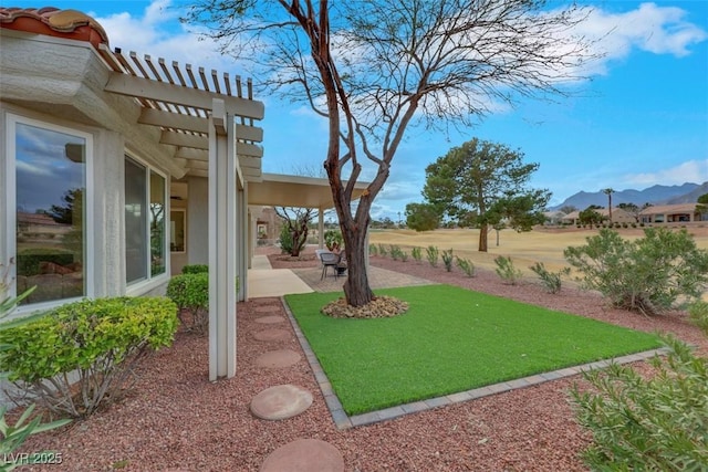 view of yard featuring a mountain view, a pergola, and a patio area