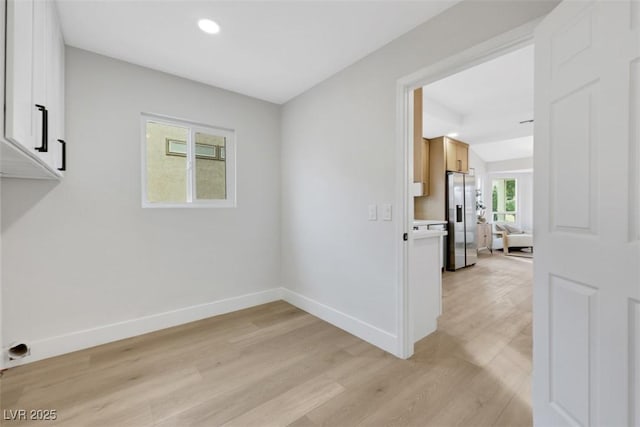 unfurnished room featuring recessed lighting, light wood-style floors, and baseboards