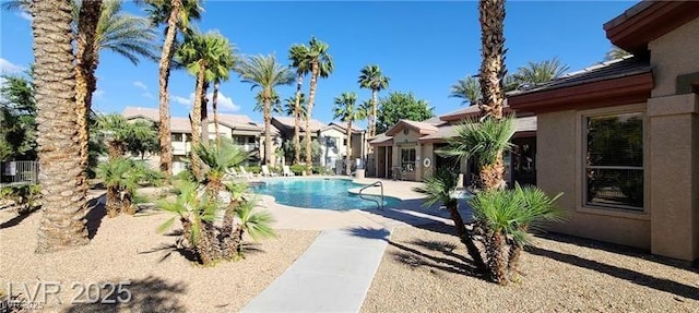 community pool with a patio area and a residential view