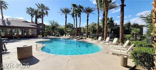 community pool featuring a patio and fence