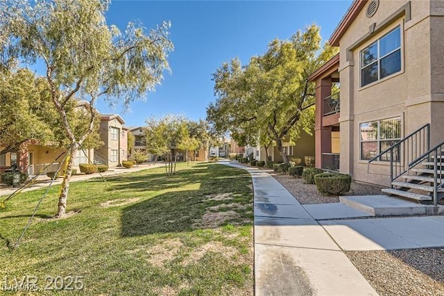 view of property's community with a lawn and a residential view