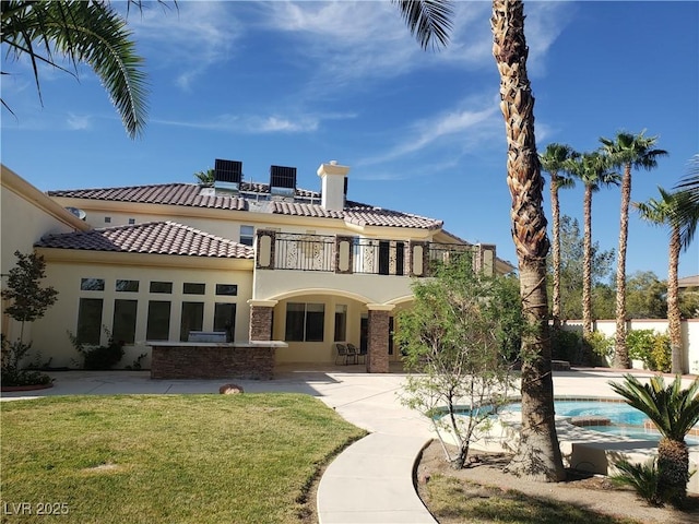 back of property with stucco siding, a patio, central AC, an outdoor pool, and a balcony