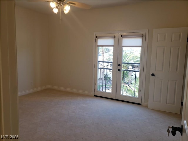 spare room with a ceiling fan, french doors, and baseboards