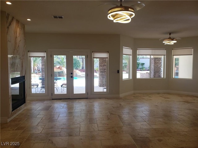 doorway with plenty of natural light, visible vents, french doors, and baseboards