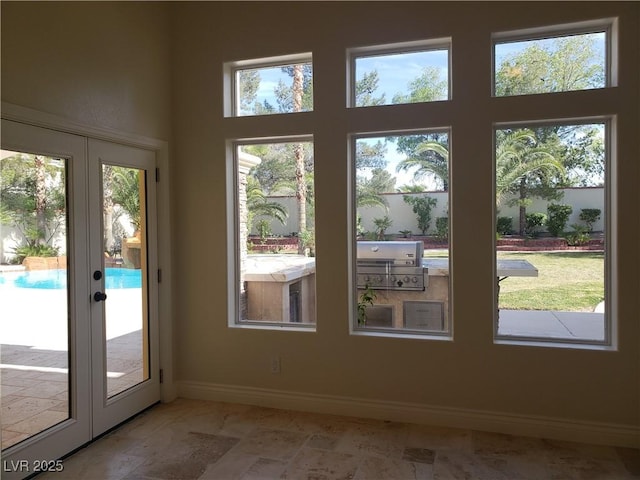 entryway with french doors, baseboards, and a healthy amount of sunlight