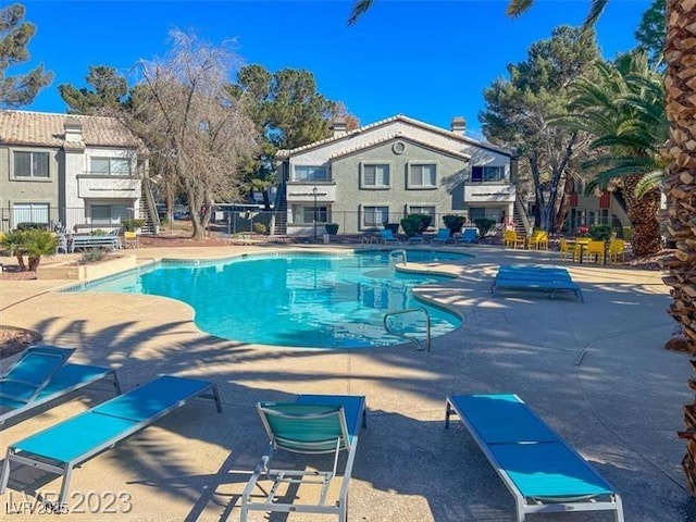 community pool featuring a patio area and fence