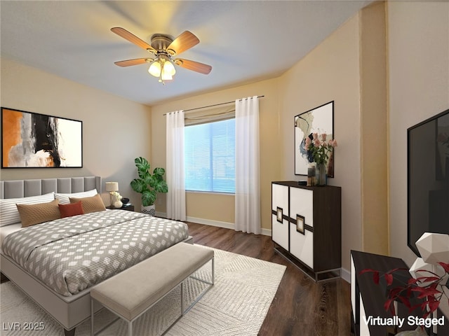 bedroom with dark wood-type flooring, a ceiling fan, and baseboards