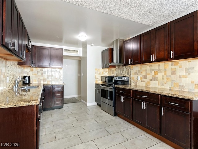 kitchen with a sink, light stone counters, stainless steel electric stove, tasteful backsplash, and wall chimney range hood