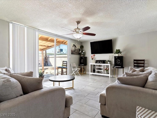 living area with a textured ceiling and ceiling fan