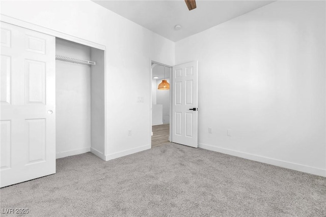 unfurnished bedroom with baseboards, carpet floors, a closet, and ceiling fan