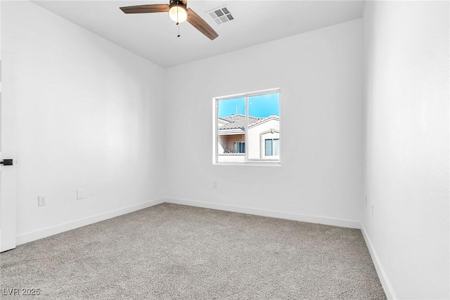 carpeted empty room featuring visible vents, baseboards, and a ceiling fan