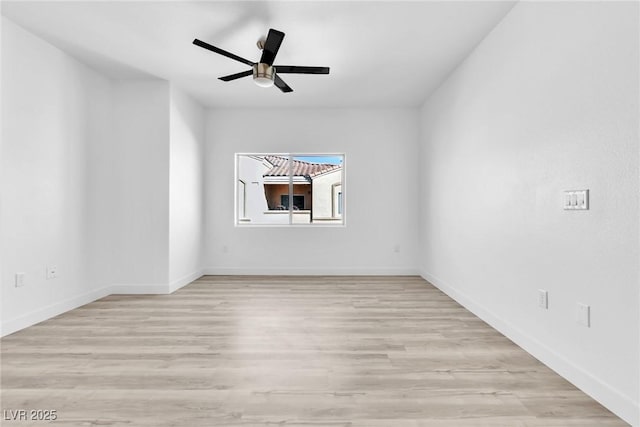 empty room featuring baseboards, ceiling fan, and light wood finished floors