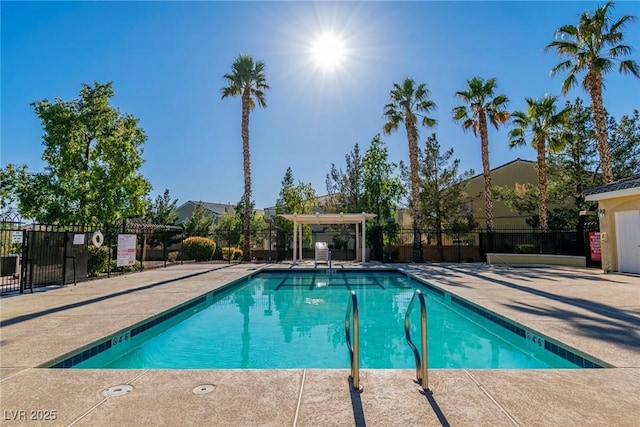 view of swimming pool featuring fence