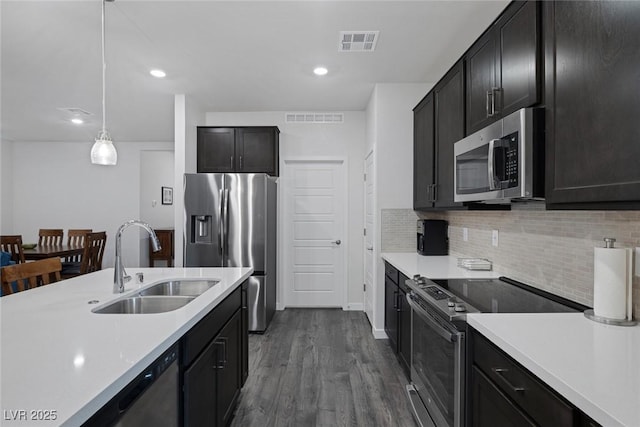 kitchen featuring a sink, light countertops, visible vents, and stainless steel appliances