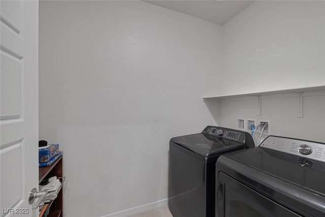 laundry area with laundry area, baseboards, and washer and clothes dryer