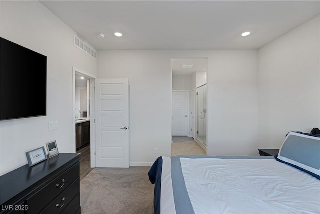 bedroom with a sink, recessed lighting, visible vents, and light carpet