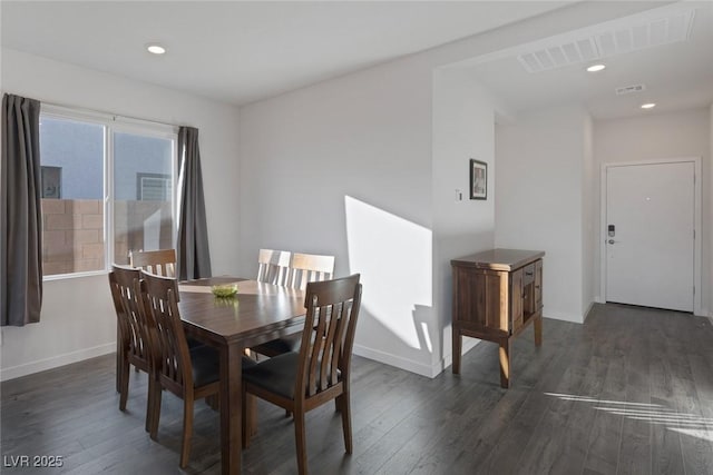 dining room with dark wood finished floors, baseboards, and visible vents