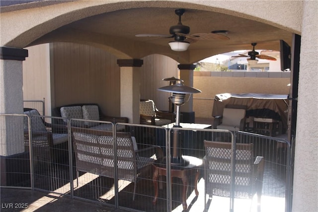 view of patio featuring ceiling fan and fence