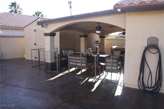 view of patio / terrace featuring ceiling fan and fence