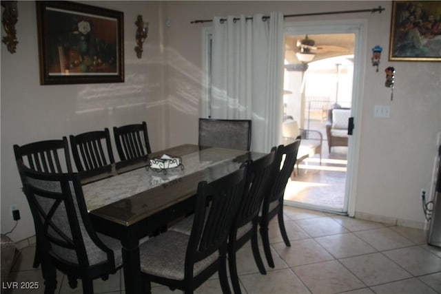 dining room featuring baseboards and light tile patterned flooring