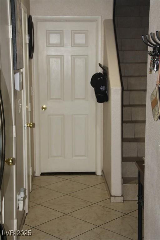 doorway to outside with light tile patterned flooring