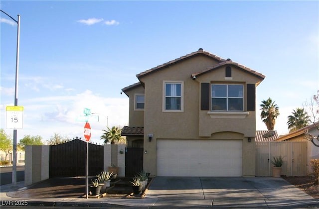 traditional-style house with stucco siding, a tiled roof, a garage, and a gate