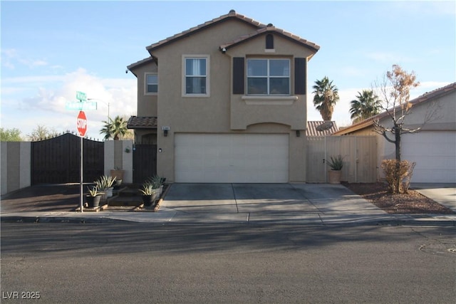 traditional home featuring a tile roof, stucco siding, concrete driveway, and a gate