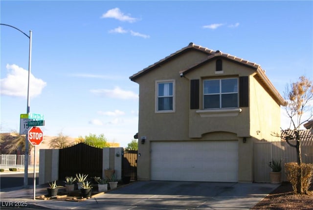 traditional home with concrete driveway, fence, a garage, and stucco siding