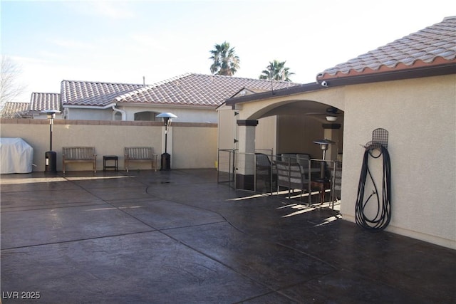 view of patio with grilling area and fence