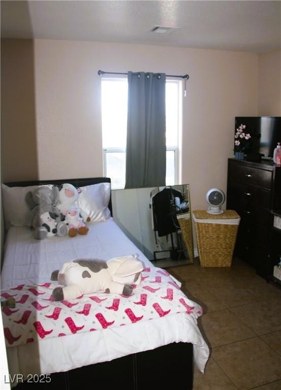 bedroom with tile patterned flooring and visible vents