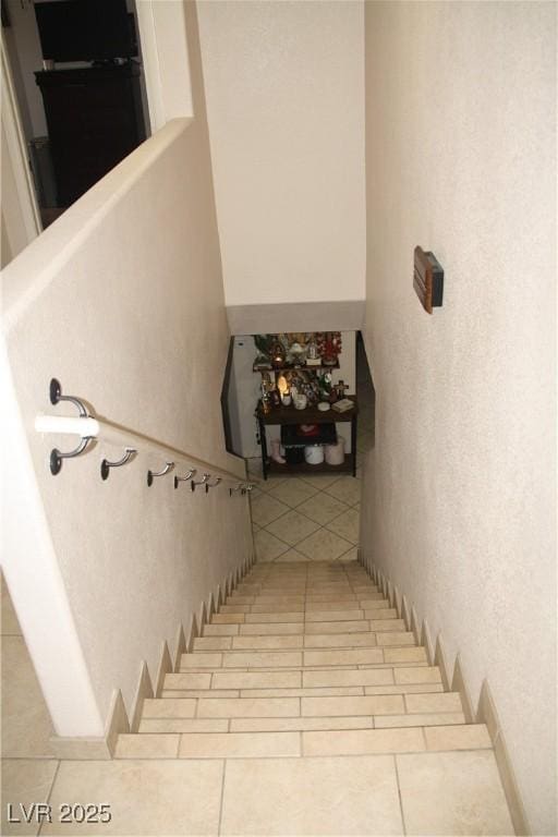 stairs featuring tile patterned flooring