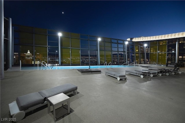 view of pool at night