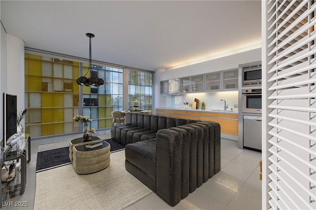 living room with light tile patterned floors and a wall of windows